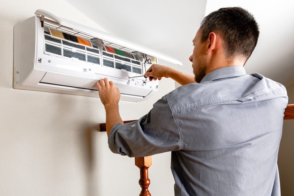 AR Cooling Solutions technician installing an air conditioner